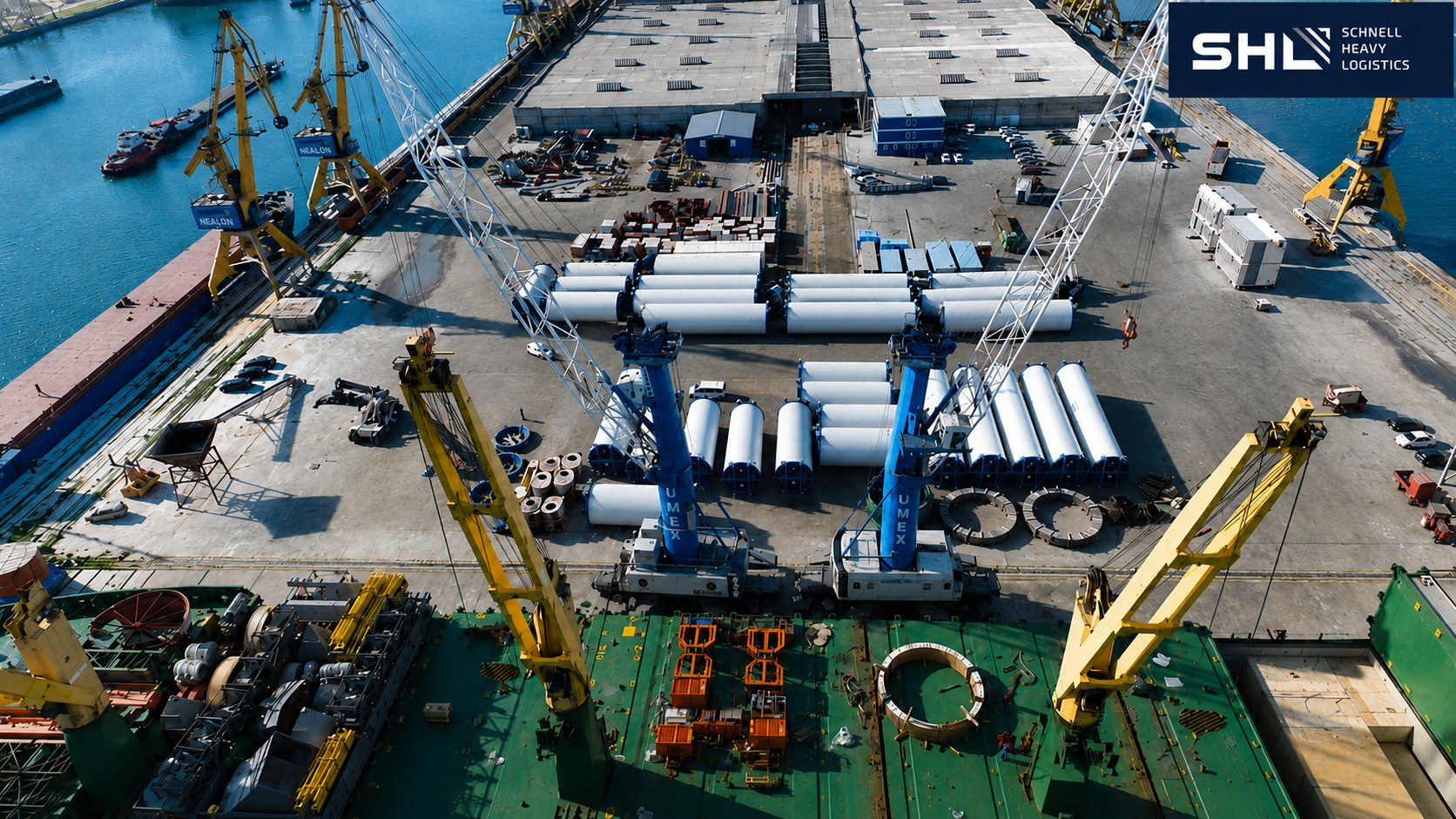 SHL Schnell Heavy Logistics — aerial view of port operations with wind turbine project cargo